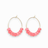 Gold hoop earrings with pink jade beads on a white background