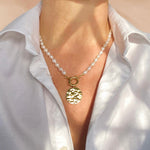 Pearl necklace, hand knotted with big 18C gold clasp and big textured pendant